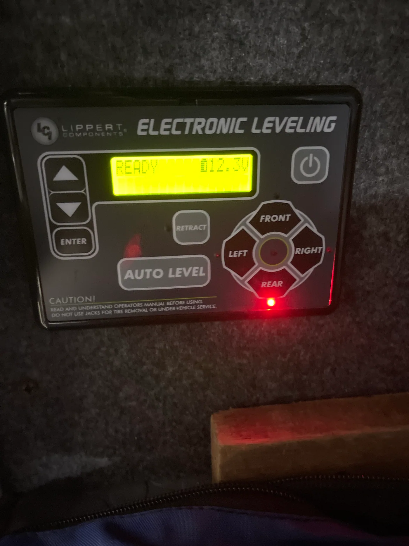 Lippert electronic leveling panel displaying battery voltage and jack status