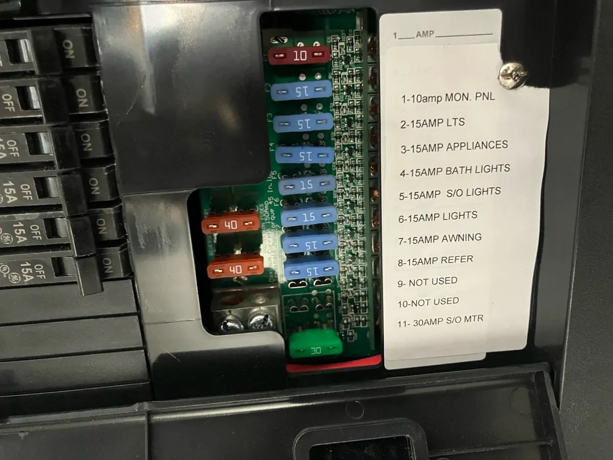 RV 12-volt distribution panel with a 15-amp awning fuse identified on the circuit label