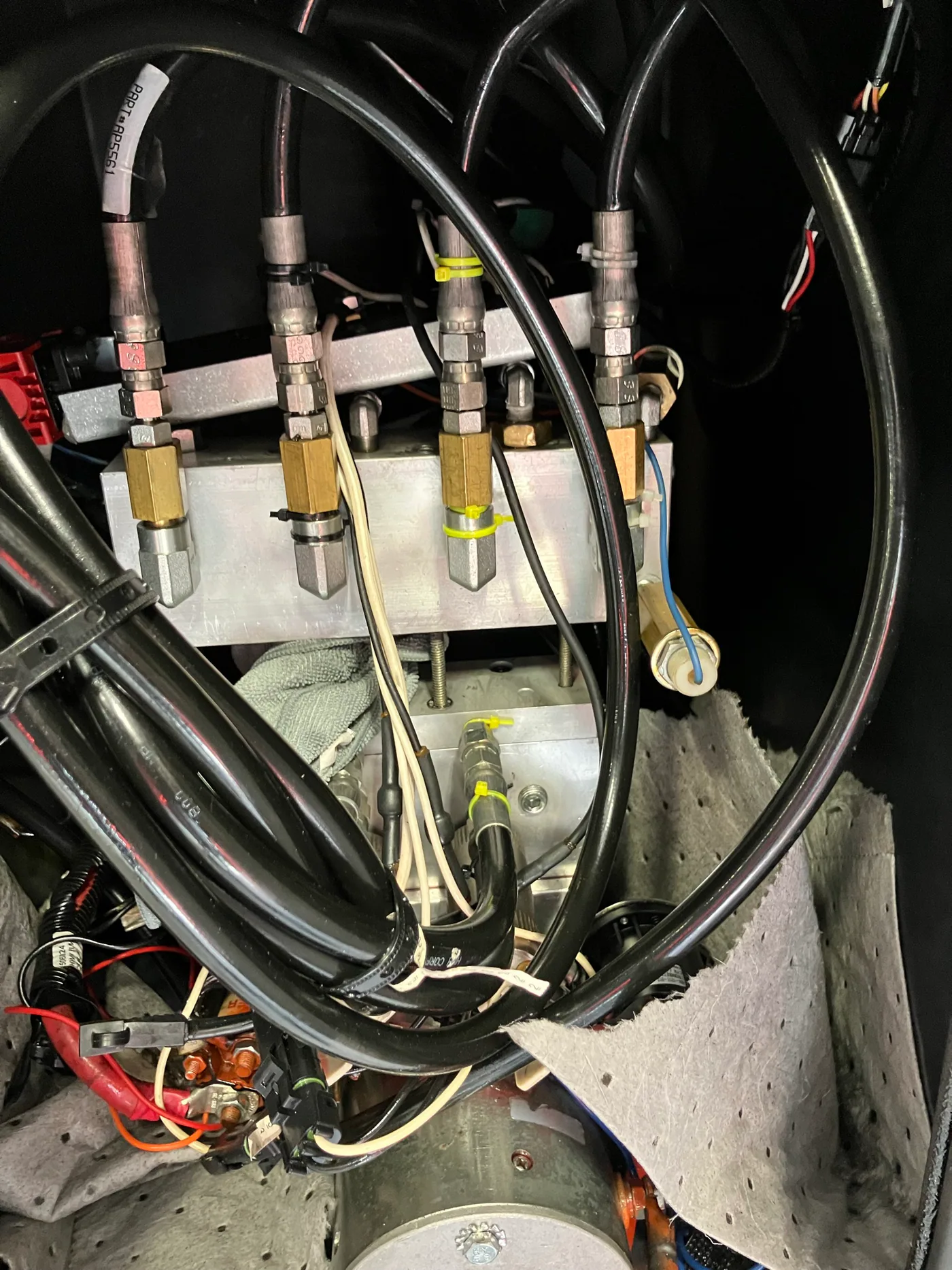 RV hydraulic manifold with multiple hoses, valves and electrical connections