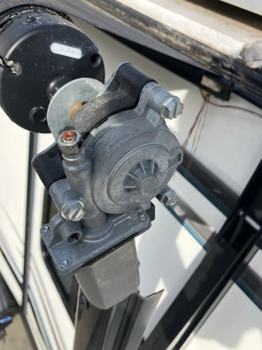 Exposed 12-volt motor and gearbox in an RV power awning drive head