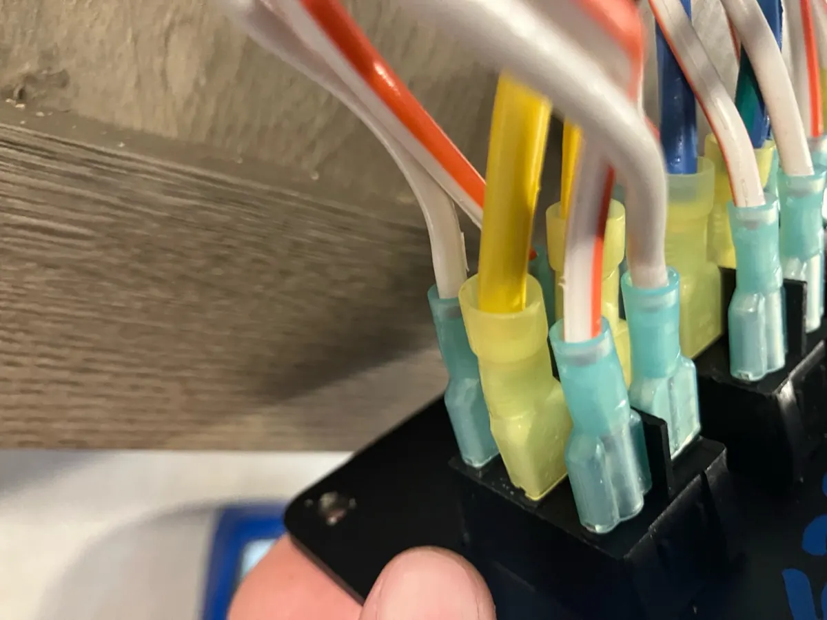 Rear of a six-terminal RV power awning reversing rocker switch with insulated wire terminals