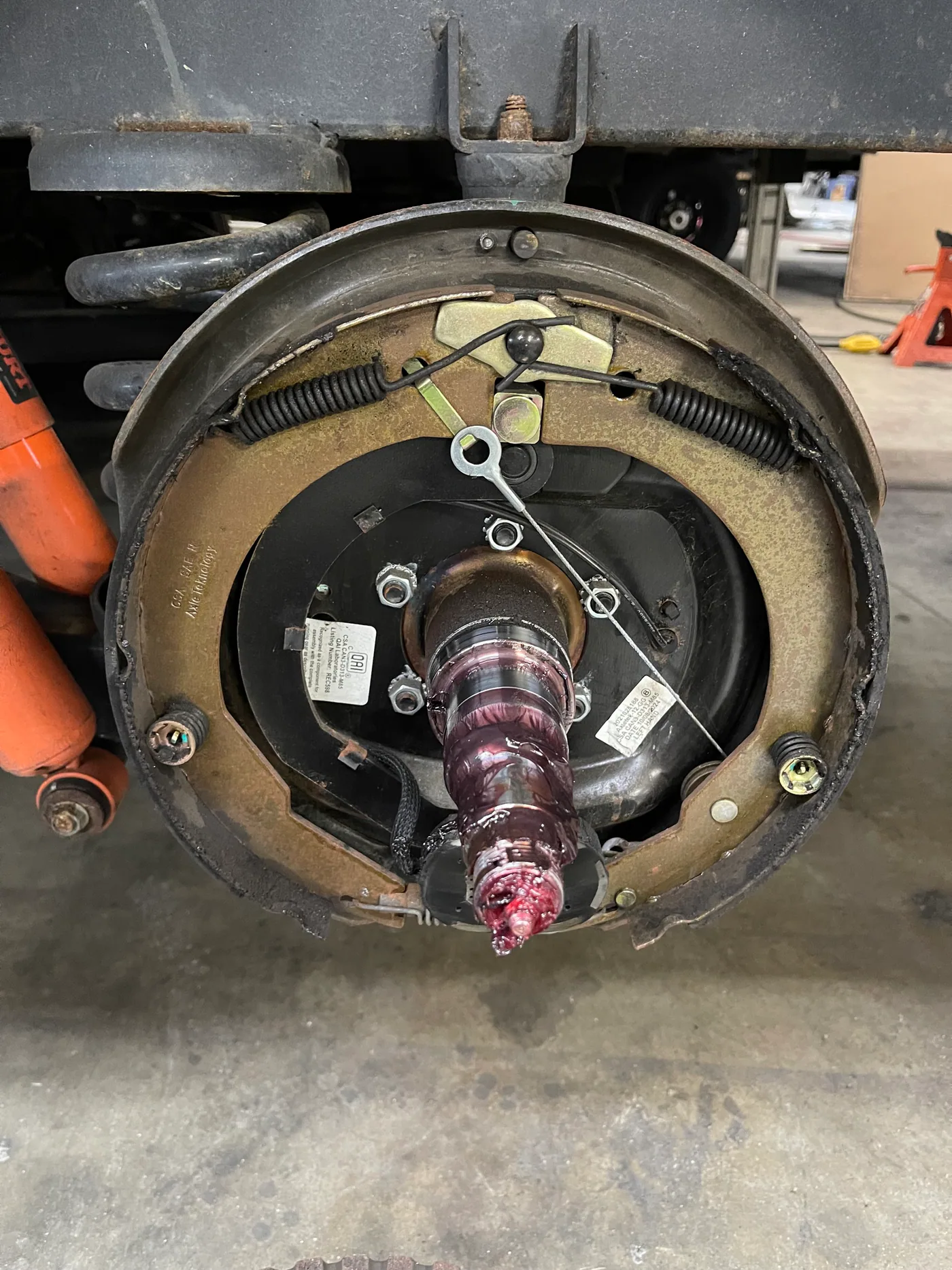 Electric RV trailer brake shoes, magnet, springs and adjuster exposed for weak-brake inspection